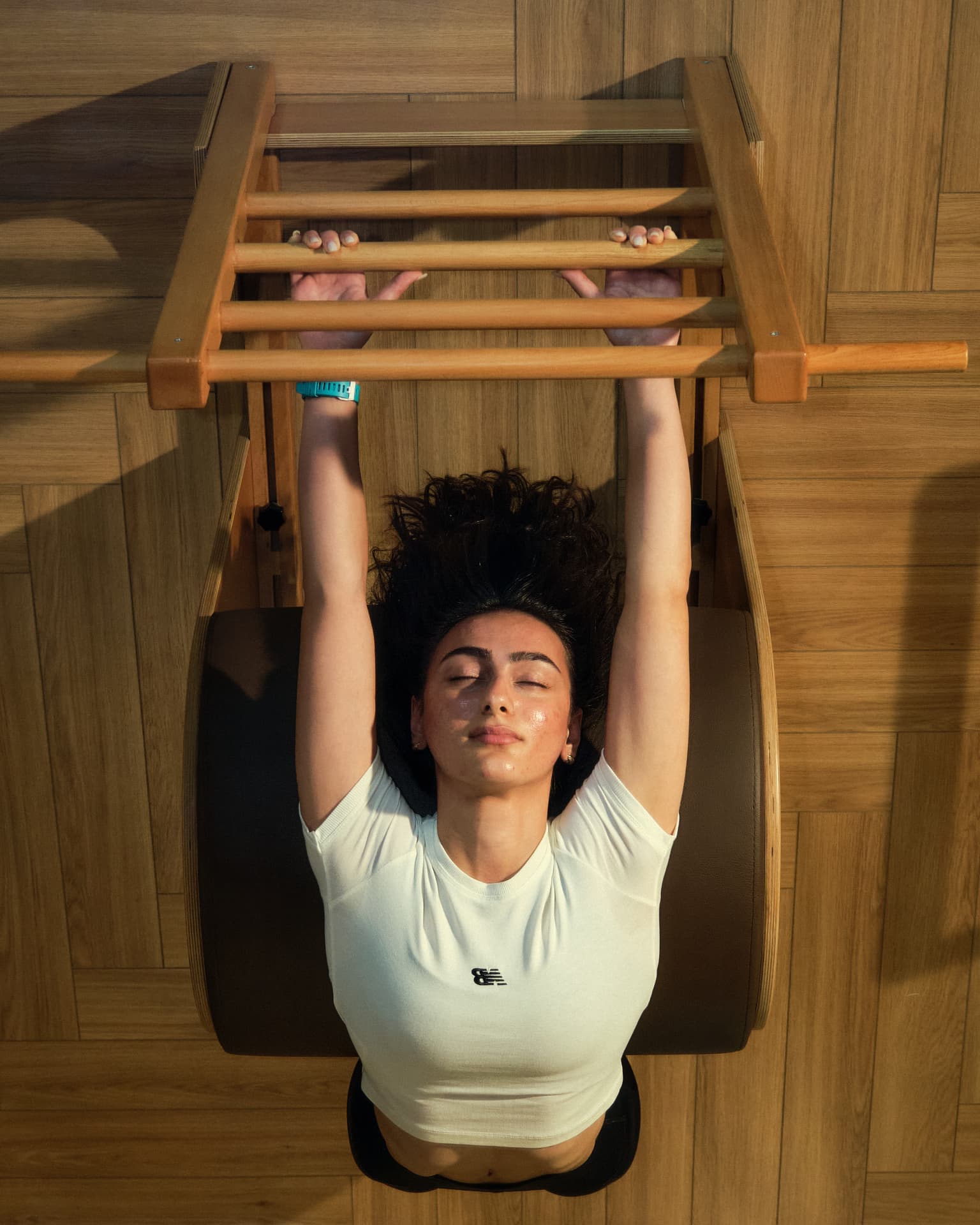 A member resting on the ladder barrel in afternoon light