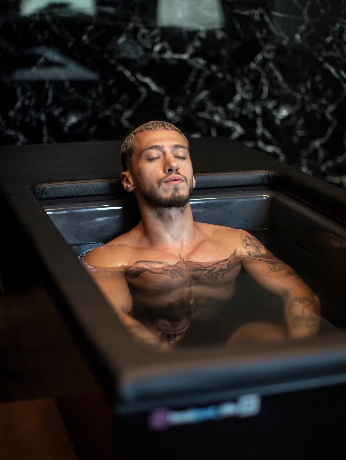 A member sitting in the cold plunge