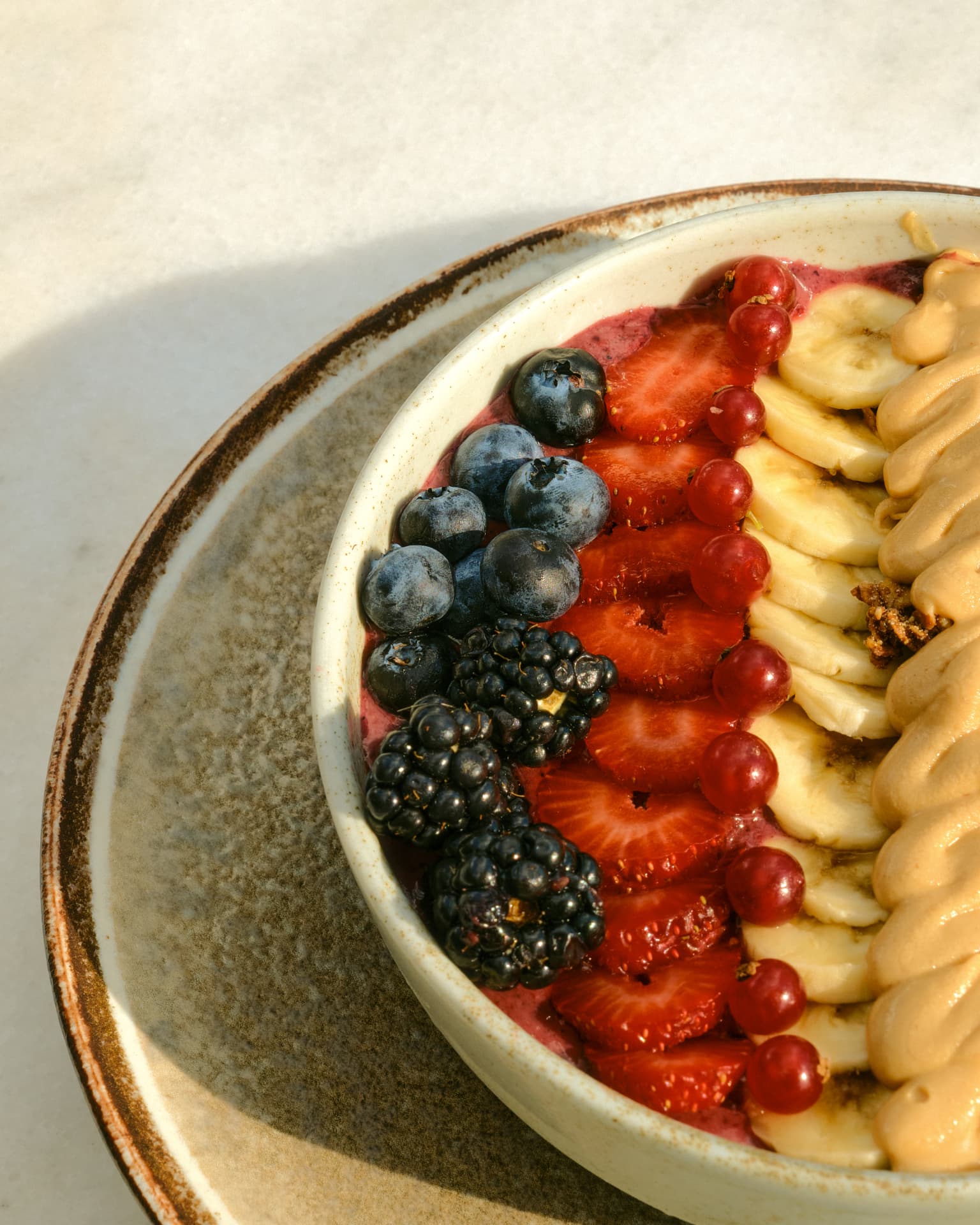 Acai bowl with berries, banana and peanut butter
